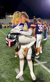 Mom's Straddling Hug With Teen Son At Football Game Goes Viral