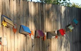 A simple white tent can be transformed into a party haven with hanging lights, themed balloons, and photo displays. Pin By Ellora S Cave On Gifts Food And Crafts For Book Lovers Book Themed Party Decorations Book Themed Birthday Party Book Themed Party