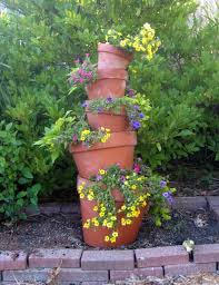 Then thread the pots onto the rod, starting with the 12 pot and filling with soil as you go. How To Make A Crooked Terra Cotta Pot Flower Tower With Annuals Dengarden