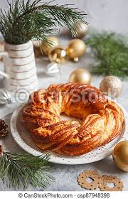 This delicious recipe for a christmas bread wreath involves woven braided dough and layers of cinnamon and sugar. Sweet Bread Wreath Decorated With Stars Cookies Honey Brioche Garland With Dried Berries And Nuts Holiday Recipes Braided Canstock
