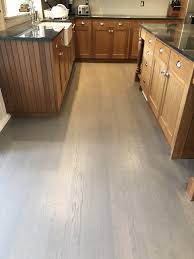 To Gray Or Not To Gray Gray Hardwood Floors A Trend Or A Tradition Valenti Flooring Grey Hardwood Floors Dark Brown Cabinets Grey Flooring