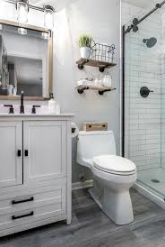 Choosing a mounted sink instead of a full vanity allowed space for a garbage can and small storage stool that can tuck behind the sink, as well as towel hooks just outside the shower door. Bathroom Design Small Master Bathroom Guest Bathroom Remodel Bathrooms Remodel