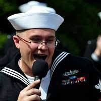 SEAMAN Apprentice Manuel D. Martin raises the US flag