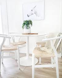 Whitelanedecor Whitelanedecor White Tulip Table With White Wishbone Chairs Dining Room Ideas Horse Frame Wishbone Chair Dining White Dining Room Tulip Table