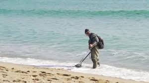 Deciding to try their luck in a different area, p.k. Man Metal Detector Looking Valuable Things Beach Cold Wheather Video By C Prafesor Stock Footage 237899196