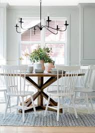 Bria Hammel Interiors White Windsor Chairs Sit On A Black And White Rug And Farmhouse Dining Room Table Round Dining Room Table Modern Farmhouse Dining Room