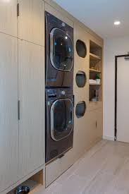 This laundry room design incorporates elements of a home office, craft room and sitting room. Laundry Room Design Idea Add A Built In Clothes Sorter