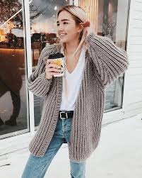 We see a black swimsuit with a deep neckline worn under a long chunky knit cardigan. How To Style A Chunky Knit Cardigan 15 Ideas Styleoholic