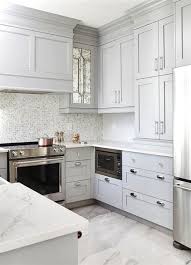 Small Gray U Shaped Kitchen Clad In Polished Marble Floor Tiles Boasts Stacked Gray Shaker Cabinet Fi Kitchen Remodel Small Kitchen Layout Small White Kitchens