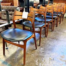It shows a standing sideways armchair of natural teak wood. 6 Erik Buch Danish Modern Dining Chairs Kudzu Antiques