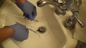 cleaning a hair clog from a sink using