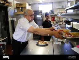 Florida, USA. 18th Nov, 2016. Owner Peter Roubekas works in the kitchen at  Farmer Girl Restaurant in Lake Worth Thursday, November 27, 2014. ''We have  been serving