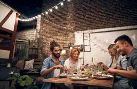In sort of denotes being inside something, but what if your backyard is some big open field with no fences or gates? Friends Having A Barbecue In The Backyard Eating Together Stockphoto