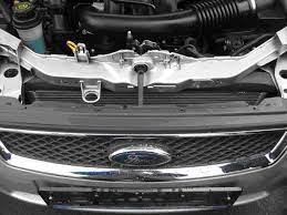 A person pops the hood open, and then disconnects the horn. How To Open The Hood On Ford Focus 2