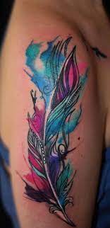 The shades of blue and yellow are mesmerizing and turn the leg into a canvas. 100 Most Beautiful Watercolor Tattoo Ideas Feather Tattoos Tattoos Shoulder Tattoo