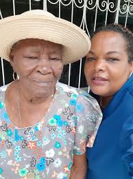 DOMLEC employees pose with centenarian Mionette Gussie Bannis along with  her grandson and caretaker Clayton Bonnie.#DOMLECcentenarians