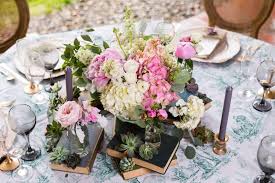 Allyson's flowers & gifts delivers flowers by hand from a real florist Vintage Inspired Wedding Table Centerpiece Hydrangea And Pink Peony Floral Arrangements Surrounded By Bud Vases And Succulents Stacked On Old Hard Cover Books Vintage Tablecloth Gold Chargers Gold Flatware Kyo Morishima