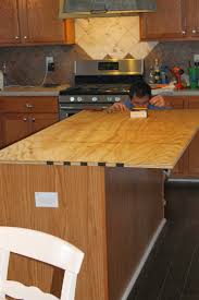 Next, cut your new countertops to the correct size, set the countertops down, and cut out the shapes of the appliances. Remodelaholic How To Create Faux Reclaimed Wood Countertops
