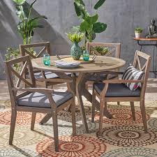 An outdoor dining table can have as many uses as you have things to put on it. Josephine Outdoor 5 Piece Acacia Wood Round Dining Set With Cushions Gray Dark Gray Walmart Com Outdoor Dining Chair Cushions Patio Furniture Deals Outdoor Dining Set