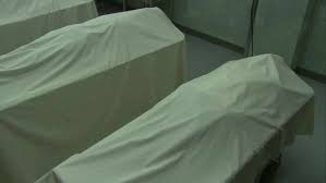 Pan right to left of five dead bodies covered with sheets in morgue. Could  be in hospital. Man, doctor or attendant. - Stock Video Footage - Dissolve