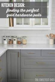 Here, the bottom of the overhead cabinets with a gold mirrored material for a little shine the silver fixtures and hardware on the black cabinets correspond with the gray leather bar stools. How To Choose And Install Gold Hardware Pulls In Your Kitchen The Sweetest Digs