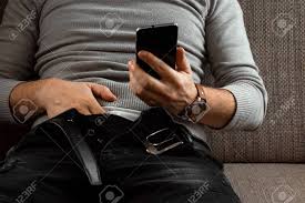 A Man Watches An Adult Video On A Phone While Sitting On A Couch. The  Concept Of Porn, Masturbation, Male Needs, Pervert, Lust, Desire,  Loneliness. Stock Photo, Picture and Royalty Free Image.