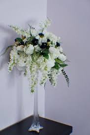 Making a wedding bouquet with artificial flowers is pretty similar to making a bouquet with real flowers. Extra Large Wedding Centerpiece Cascading Centerpiece Silk Wedding Flowers Roses Fern Ranunculuses Wisteria Wedding Decor Flowers In 2021 Wedding Centerpieces Silk Flowers Wedding Wedding Table Centerpieces Elegant