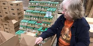 Volunteers spend time helping pack boxes of food