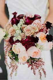 An ivory and burgundy rose artificial wedding bouquets finished with crystal strands. Wedding Bouquet Ideas Inspiration With Soft Pink And Rose Gold Flowers And Marsala Peonies Colorful Wedding Flowers Fall Wedding Bouquets Fall Wedding Colors
