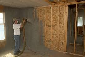 First you use a utility knife to cut the bag in half, then use your hands to break up the material into the blower (making sure to keep your hands above the safety guard, which is about 2/3 up the blower barrel). Sprayed Moisture Added Cellulose Insulation An Effect Way To Get Tightly Sealed Wall Cavities