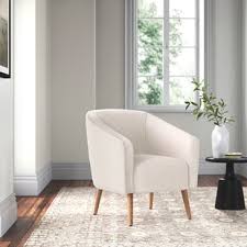 Beige sofas and chairs with wooden coffee table and cabinets. Accent Chairs Joss Main