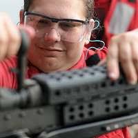 Gunnery Sgt. Jason Neale demonstrates how to change the barrel of an M-240B  machine gun.