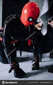 Sexy woman with her latex rubber slave in mask playing at home in bdsm  Stock Photo by ©agnadevi 321384140