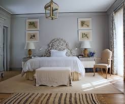 Keep the tones light and subtle, avoiding any strong color. Gray Bedroom With Upholstered Bed Via Belle Vivir