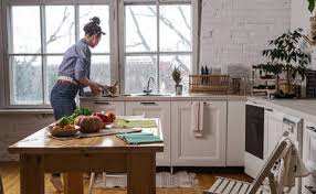 Quartz countertops can look beautiful in white kitchens and keep the whole space looking light and elegant. Young And Beautiful Housewife Woman Cooking In A White Kitchen Stockphoto