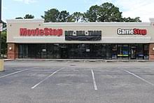 This logo image consists only of simple geometric shapes or text. Gamestop Wikipedia