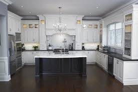 Stylish white kitchen cabinets accented with dark stained countertops and black hardware for a bold look. 15 Affordable Black And White Kitchen Cabinets Lmolnar Kitchen Remodel Small Kitchen Remodel Countertops Kitchen Layout