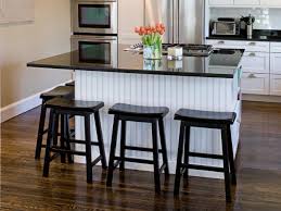 A small and narrow table with tall stools and a pendant lamp. Kitchen Islands With Breakfast Bars Hgtv