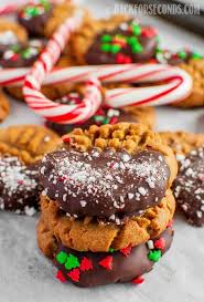 We've all seen these floating around on pinterest and it's no joke how popular theses are place pretzels on parchment covered cookie sheet. Easy Christmas Peanut Butter Cookie Recipe Back For Seconds