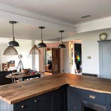 We used a sold flow of reclaimed wood in this kitchen to bring warmth back into the industrial build. Rustic Wood Kitchen Island Worktop By Earthy Timbet Wood Kitchen Rustic Kitchen Rustic Kitchen Design