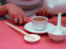 唔該 is used when someone helps you with something or performs a service for you (eg. Why The Chinese Tap 2 Fingers With Every Pour Of Tea Golden Moon Tea