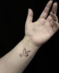 A hint of colors would make the whole design pop out even more. Dove Tattoo On Wrist
