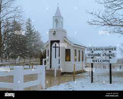 A white Living Water Wayside Chapel surrounded by trees in winter Stock  Photo - Alamy