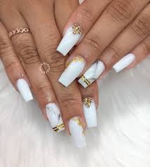 In this article we look at some of the nail designs that you could consider. White Coffin Long Marble Nails With Gold Tape And Gold Foil Designs White Nails With Gold Gold Nails White Coffin Nails