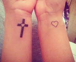 A cross tattoo is one of the most versatile, classic tattoo choices a woman can make. Cross With Heart In The Middle Fish Tattoos Tattoos Jesus Fish Tattoo