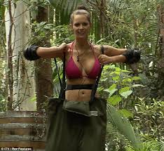 Woman wearing rubber boots with umbrella in spring nature. I M A Celebrity 2011 Jessica Jane Clement And Mark Wright Don Rubbers For Chest Task Daily Mail Online