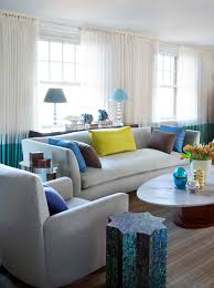 An ivory carpet and couch, taupe tables and walls, and purple accessories. Grey Couch Living Room Color Schemes Novocom Top