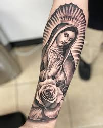 Also, there is a tiny cross inked along with the portrait. Art Amazing Virgin Mary Guadalupe Rose Arm Tattoo By