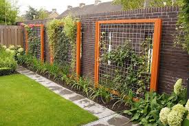 Growing vines and other vertical elements in a garden adds height, interest, expands useful space, and sometimes even acts as a privacy screen! Wood Framed Wire Trellis Diy Garden Trellis Garden Trellis Garden Vines