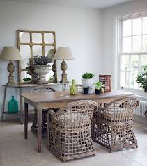 The console table features two drawers with ornate handles and a curved lower shelf. Ijlb Conservatory Lime Washed Taper Legged Table 2100 Cider Mill Demi Lune Console Table 1995 Wicker Chair 195 The English Home